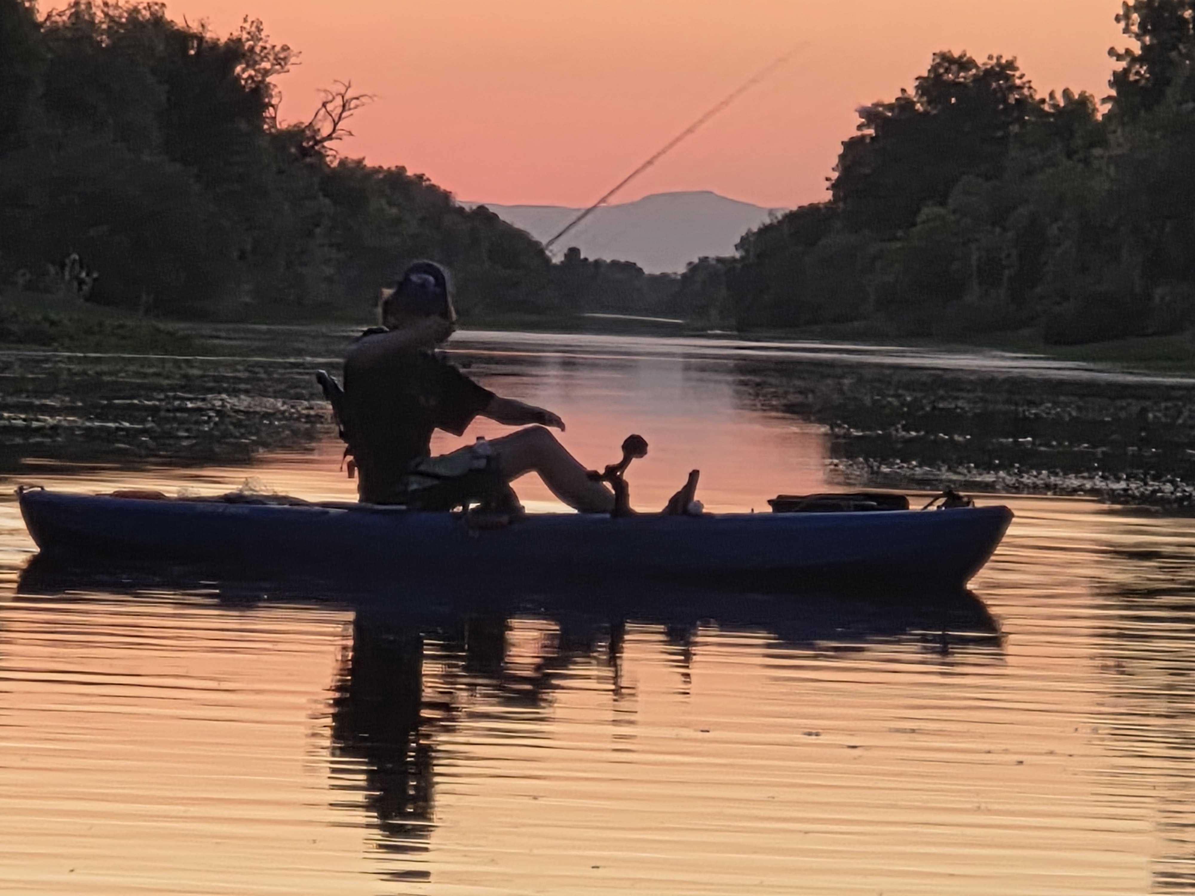 kayak fishing at sunset